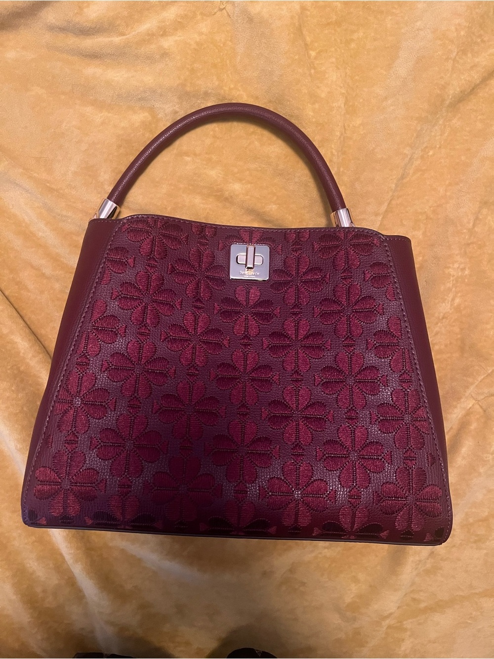 Elegant Kate Spade Floral-Embossed Burgundy Top-Handle Bag